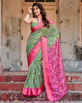Green and Pink Tussar Silk Saree with Vibrant Ikat Patterns and Zari Border